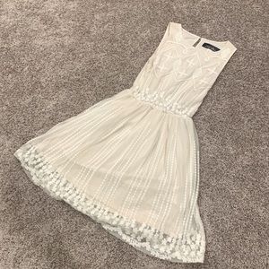 White, sheer detailed dress with attached sheath.